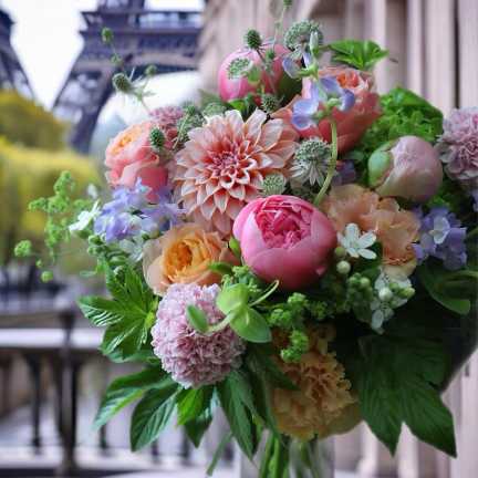 Bouquet of pink, peach, and lavender flowers with greenery