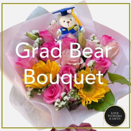 Bouquet of yellow sunflowers and pink roses with a small teddy bear in graduation attire.