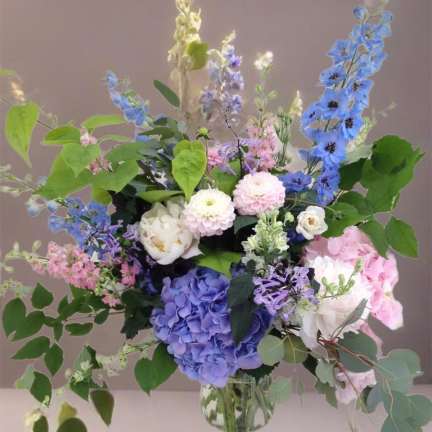Mixed pastel flower arrangement in a clear glass vase