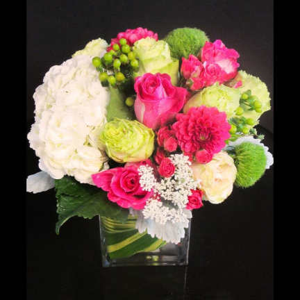 Pink and white mixed bouquet in a clear square vase