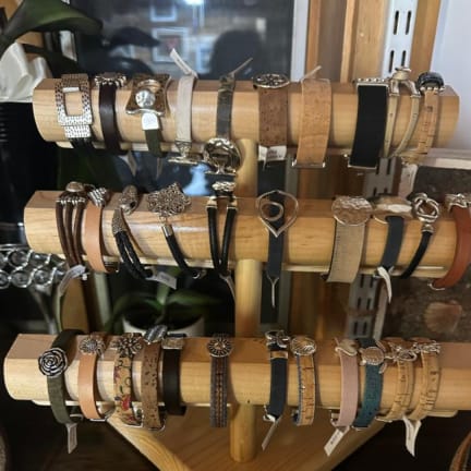 Display rack of assorted wristwatches on wooden bars