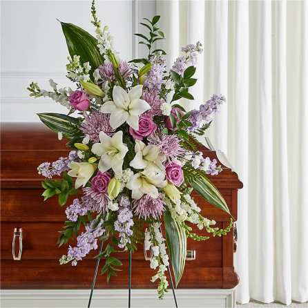 Standing floral spray with white lilies, pink roses, and lavender blooms