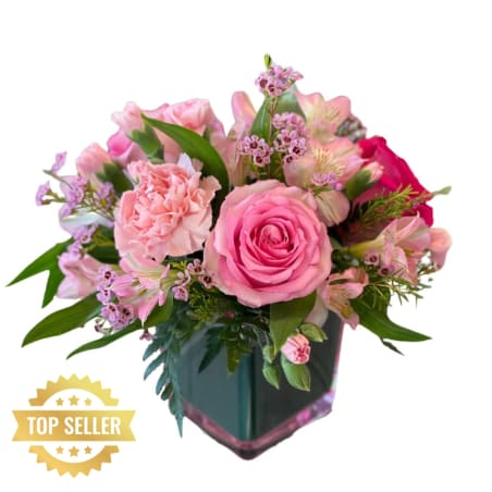 Pink roses and carnations in a dark glass vase