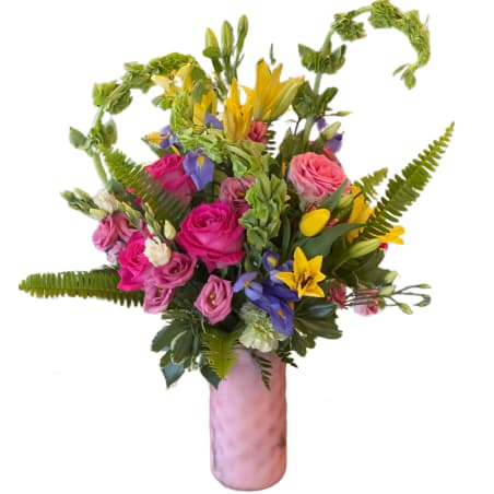Colorful bouquet of roses and lilies in a pink vase