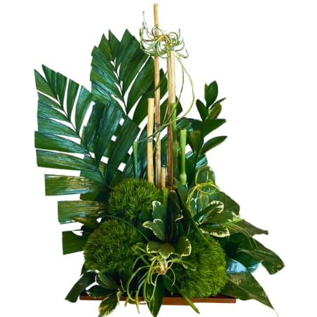 Tall green tropical arrangement with palm leaves and bamboo sticks