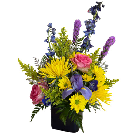 Mixed bouquet in a black vase with yellow, pink, and purple flowers