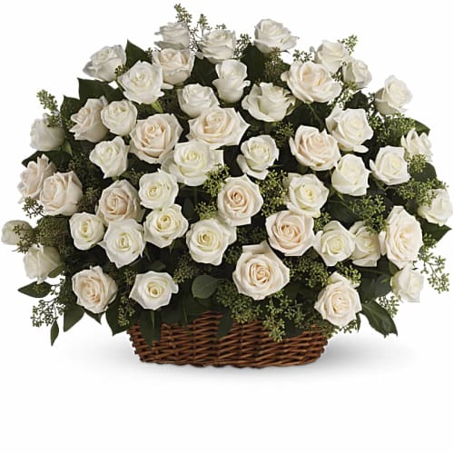 White roses arranged in a wicker basket