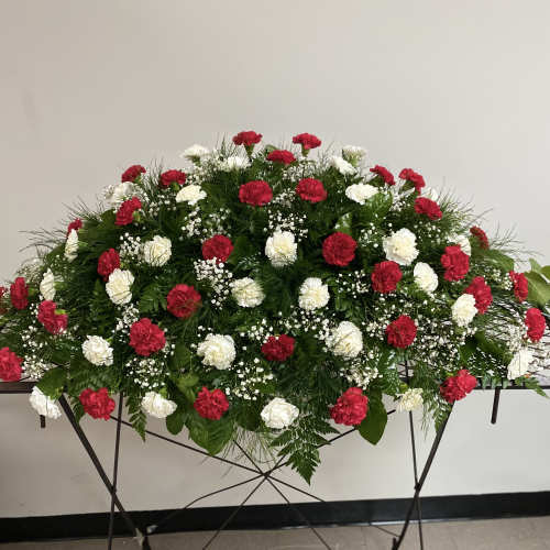 Red and white carnation arrangement on a standing table