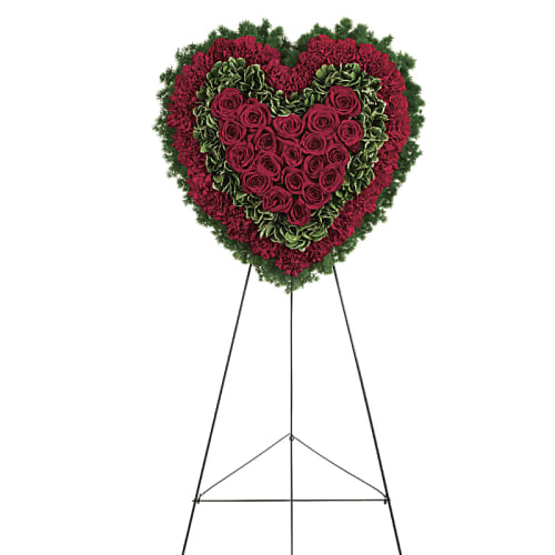 Heart-shaped standing floral tribute with red roses and carnations