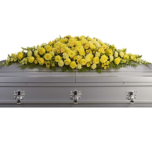 Yellow floral spray on a silver casket