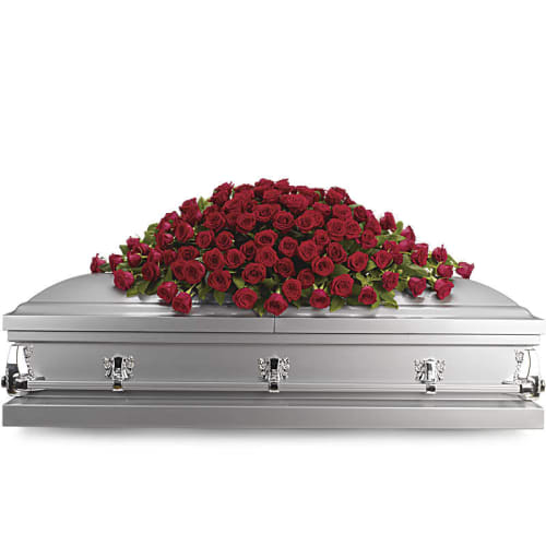 Red rose casket spray on a silver casket
