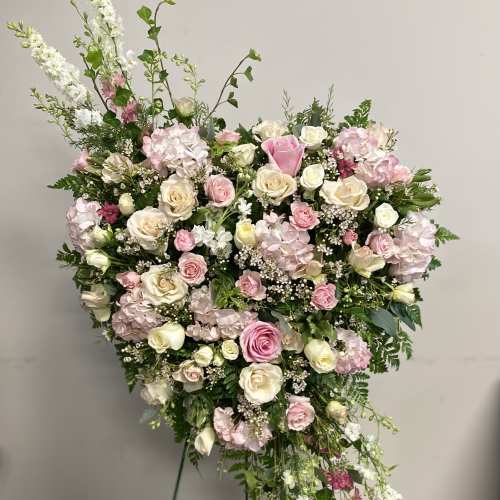 Large pink and white floral standing arrangement on a stand