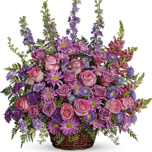 Basket arrangement of pink and purple flowers with tall spikes