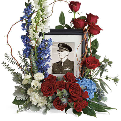 Memorial floral frame with red roses, blue delphinium, and white snapdragons