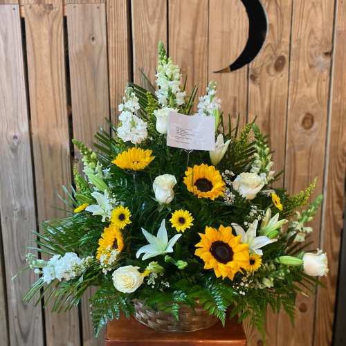 Basket arrangement with sunflowers, white roses, lilies, and snapdragons