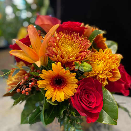 Bouquet of red roses, orange lilies, and yellow chrysanthemums