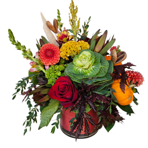 Mixed floral arrangement in a glass vase with a red rose and colorful blooms