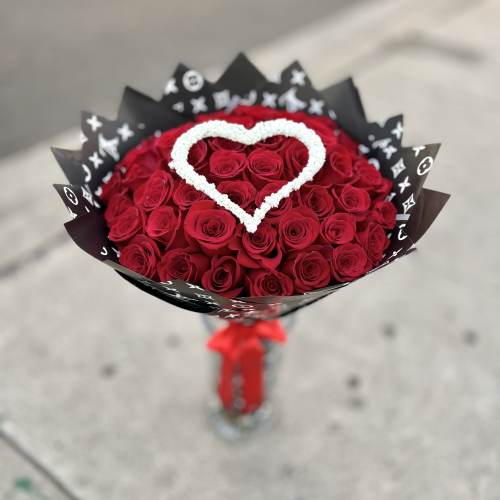 Bouquet of red roses with a white heart accent in black wrap