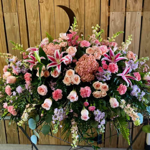 Large pink and peach floral arrangement with lilies and roses