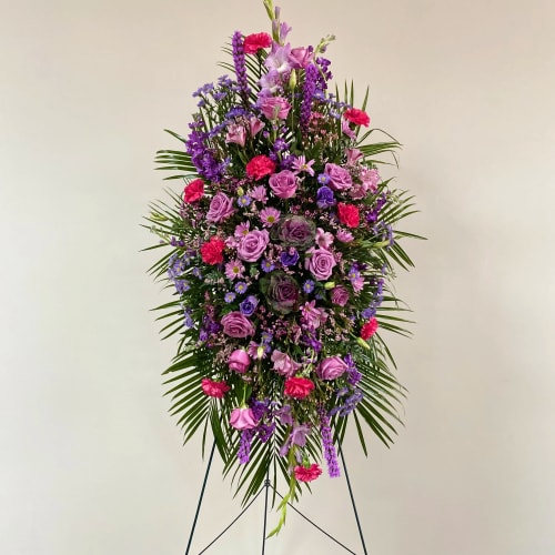 Tall standing floral spray in purple, pink, and magenta tones