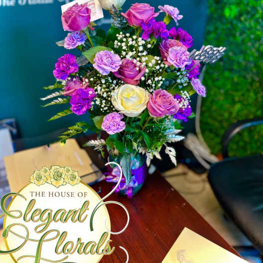Bouquet of pink, purple, and white roses in a vase