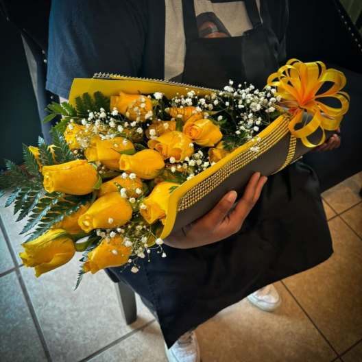 Bouquet of yellow roses with baby's breath in a decorated wrap