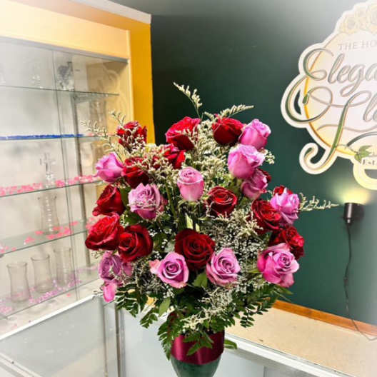 Bouquet of red and pink roses in a glass vase