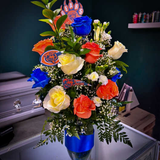 Bouquet of multicolored roses in a glass vase with Chicago Bears accents