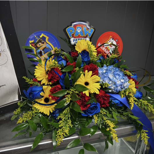 Colorful bouquet with yellow daisies, blue roses, and Paw Patrol toppers
