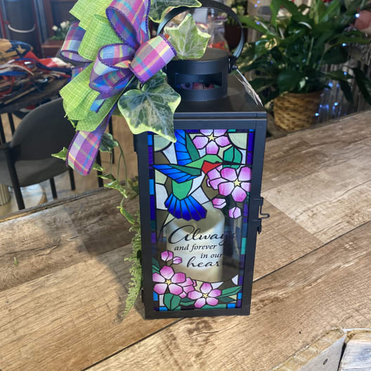 Decorative memorial lantern with a hummingbird panel and ribbon bow