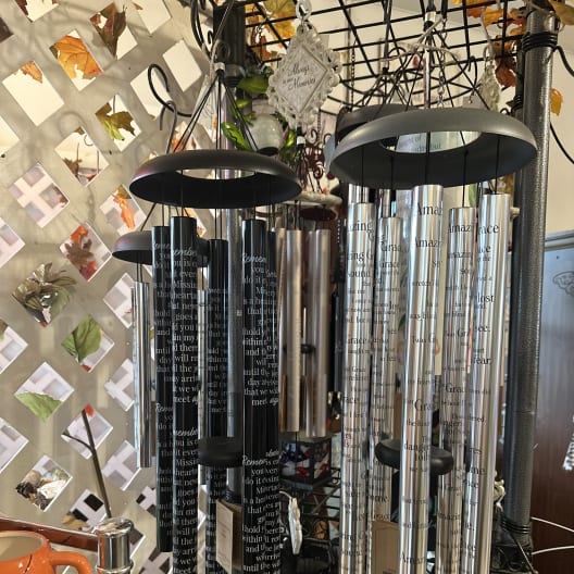 Hanging memorial wind chimes with engraved tubes and black tops