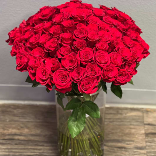 Large bouquet of red roses in a clear glass vase