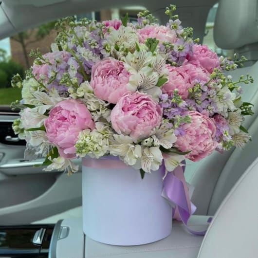 Pink peonies and white alstroemeria in a lavender hat box