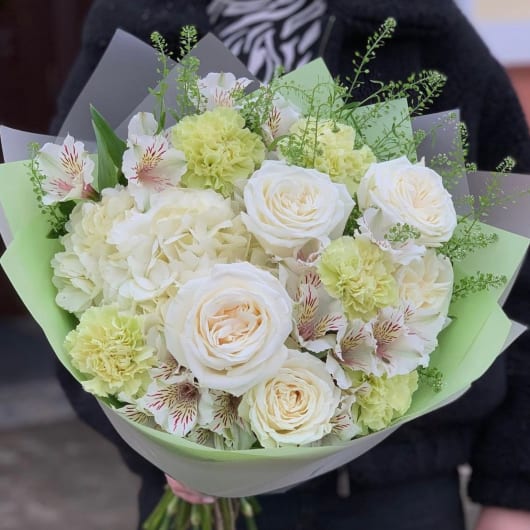 Bouquet of white roses, pale green carnations, and striped alstroemeria