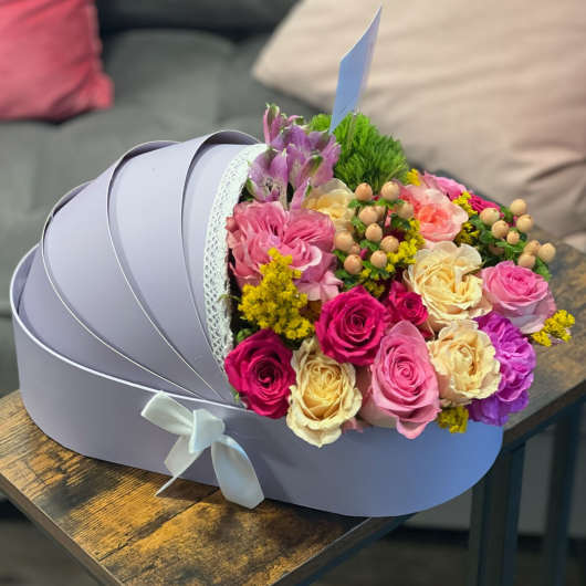 Bouquet of pink, cream, and purple roses in a lavender hat box