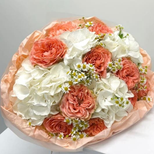 Peach roses and white hydrangeas in peach wrapping