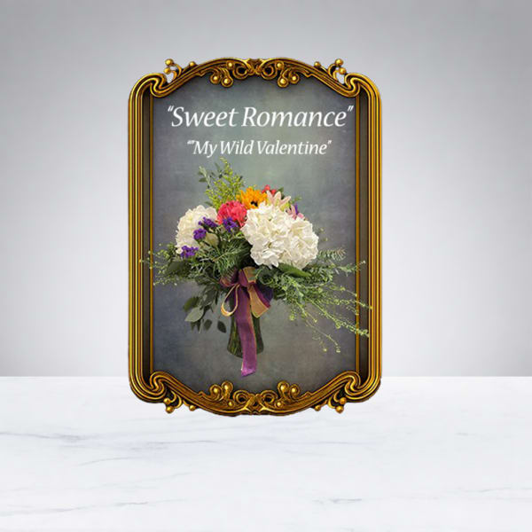 Bouquet of white and pink flowers in an ornate gold frame