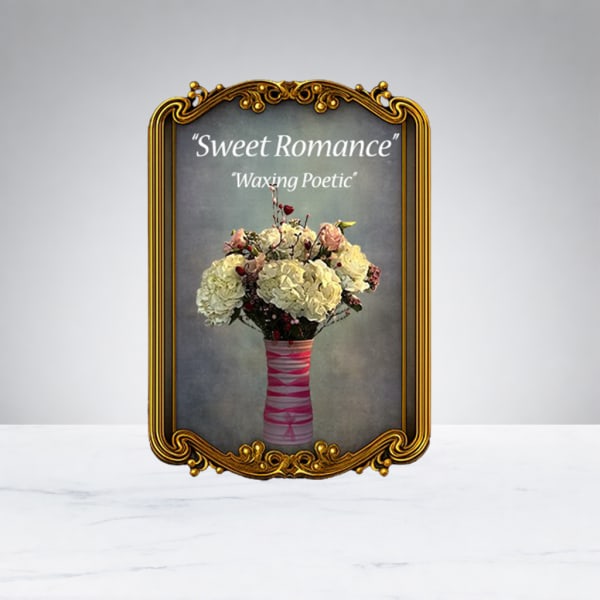 Bouquet of pale flowers in a pink-wrapped vase inside an ornate gold frame
