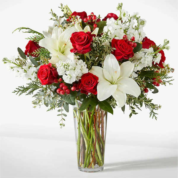 Red roses and white lilies in a clear glass vase