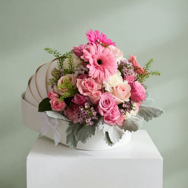 Pink and white mixed bouquet in a white hat box with a ribbon