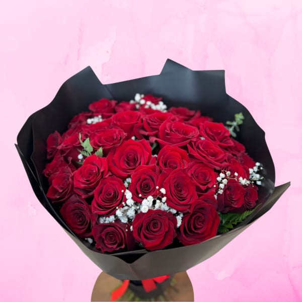 Bouquet of red roses wrapped in black paper