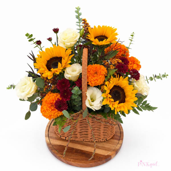 Basket arrangement with sunflowers, white roses, and orange marigolds