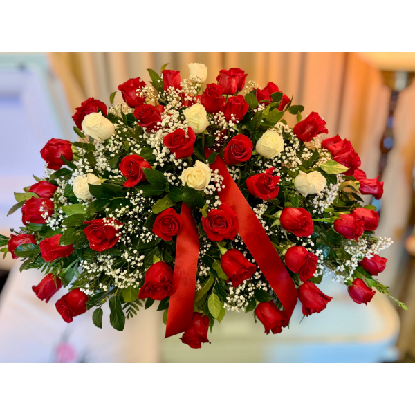 Red and white rose bouquet with baby's breath and a red ribbon