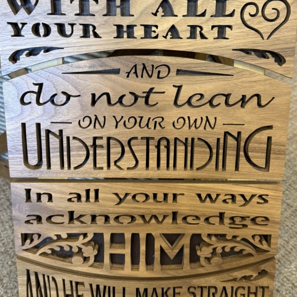 Wooden sign with cutout quote text and decorative heart accents