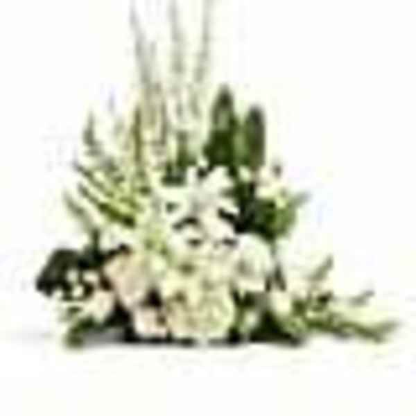 Tall white floral arrangement with dark green accents