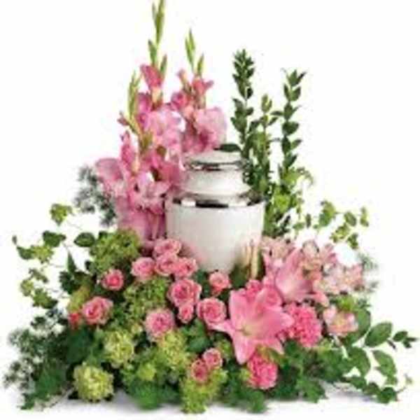 Pink floral arrangement with a white urn centerpiece