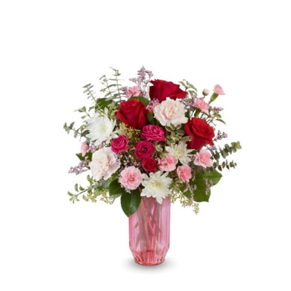 Pink and red rose bouquet in a pink glass vase