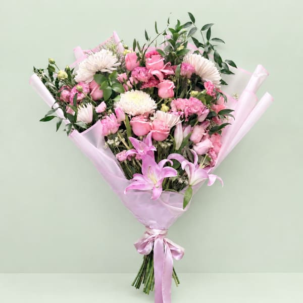 Pink and white mixed bouquet wrapped in pale pink paper