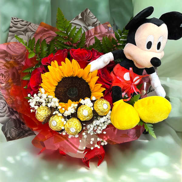 Bouquet of red roses, a sunflower, chocolates, and a Mickey Mouse plush
