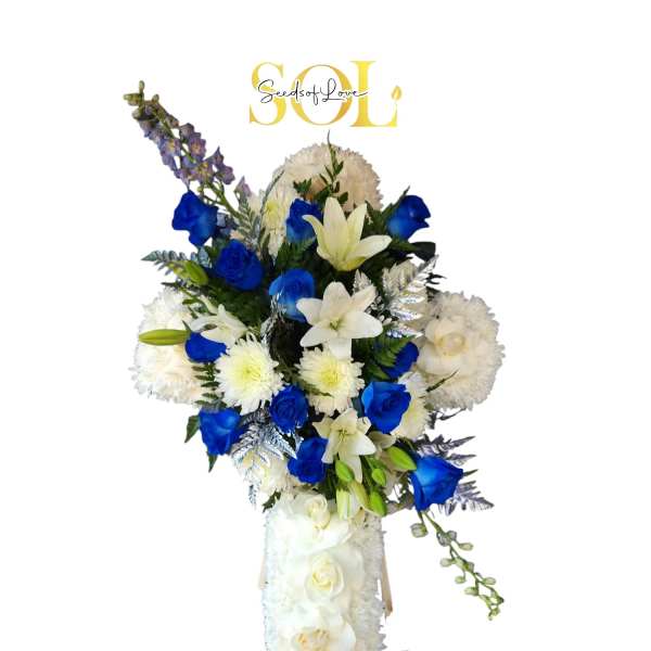 Tall white floral standing spray with blue roses and lilies